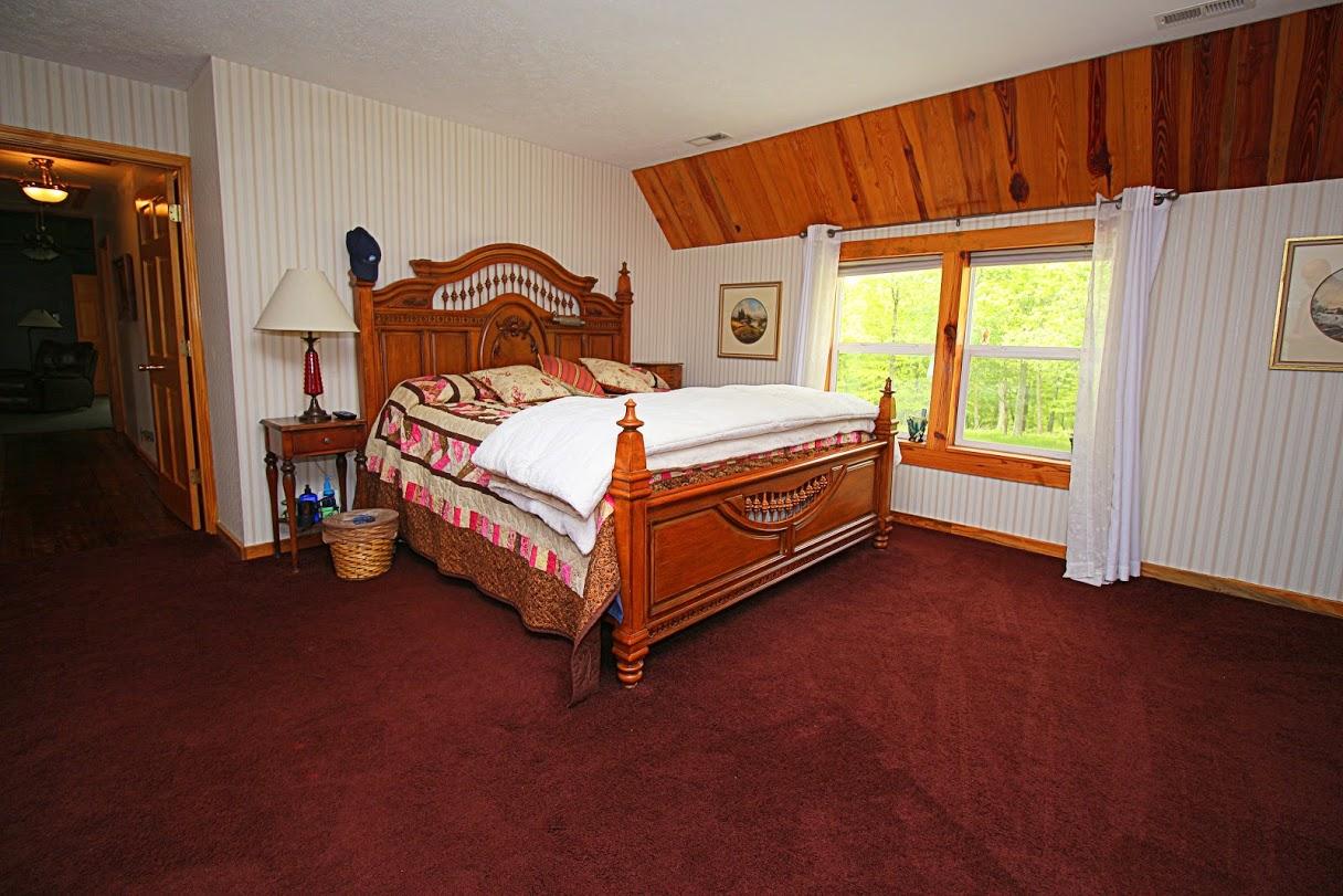 2185 Loops Road Rainelle, WV 25962 - Photo 18 of 109 a bedroom with a bed and a window