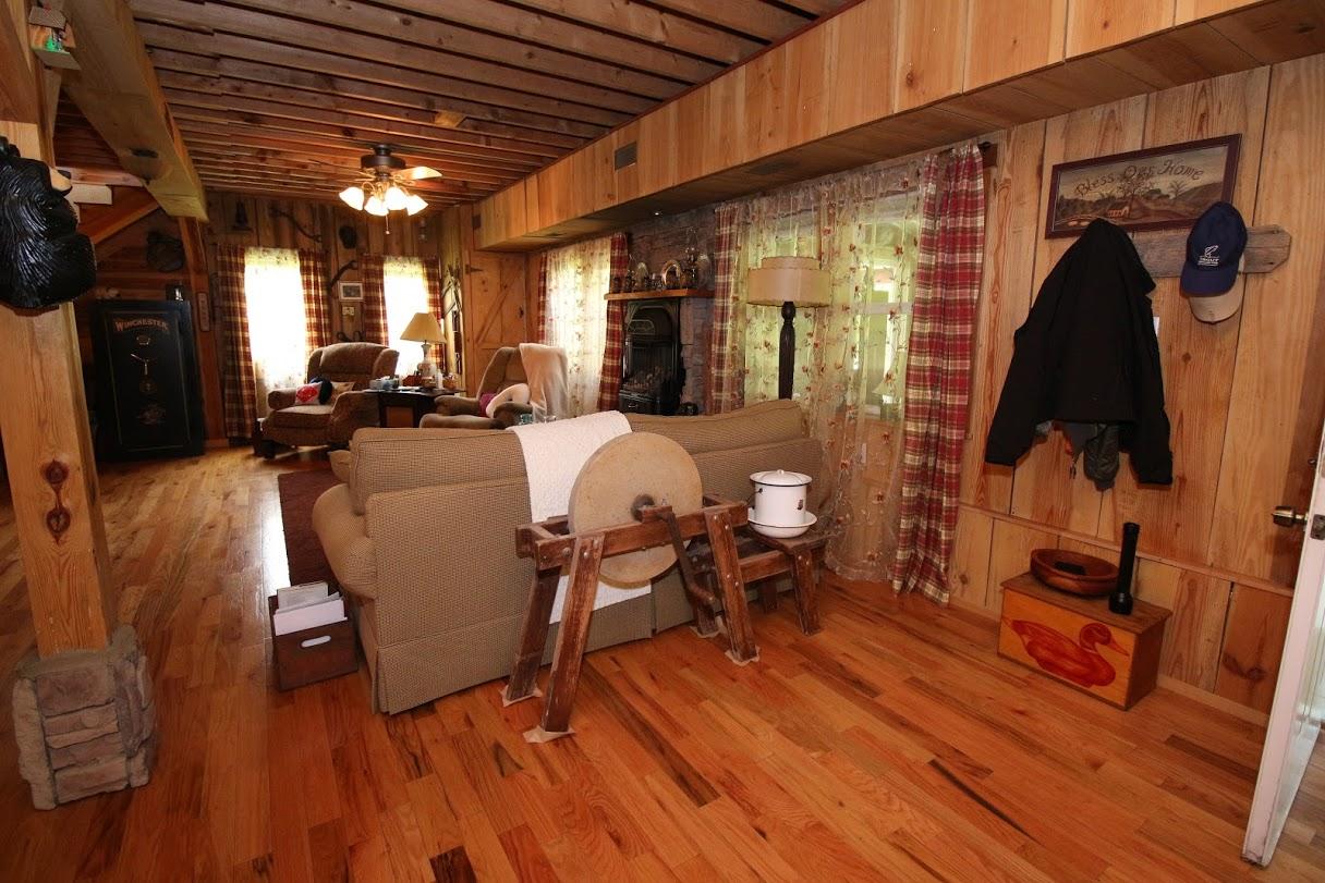 2185 Loops Road Rainelle, WV 25962 - Photo 56 of 109 a living room with furniture a flat screen tv and a wooden floor