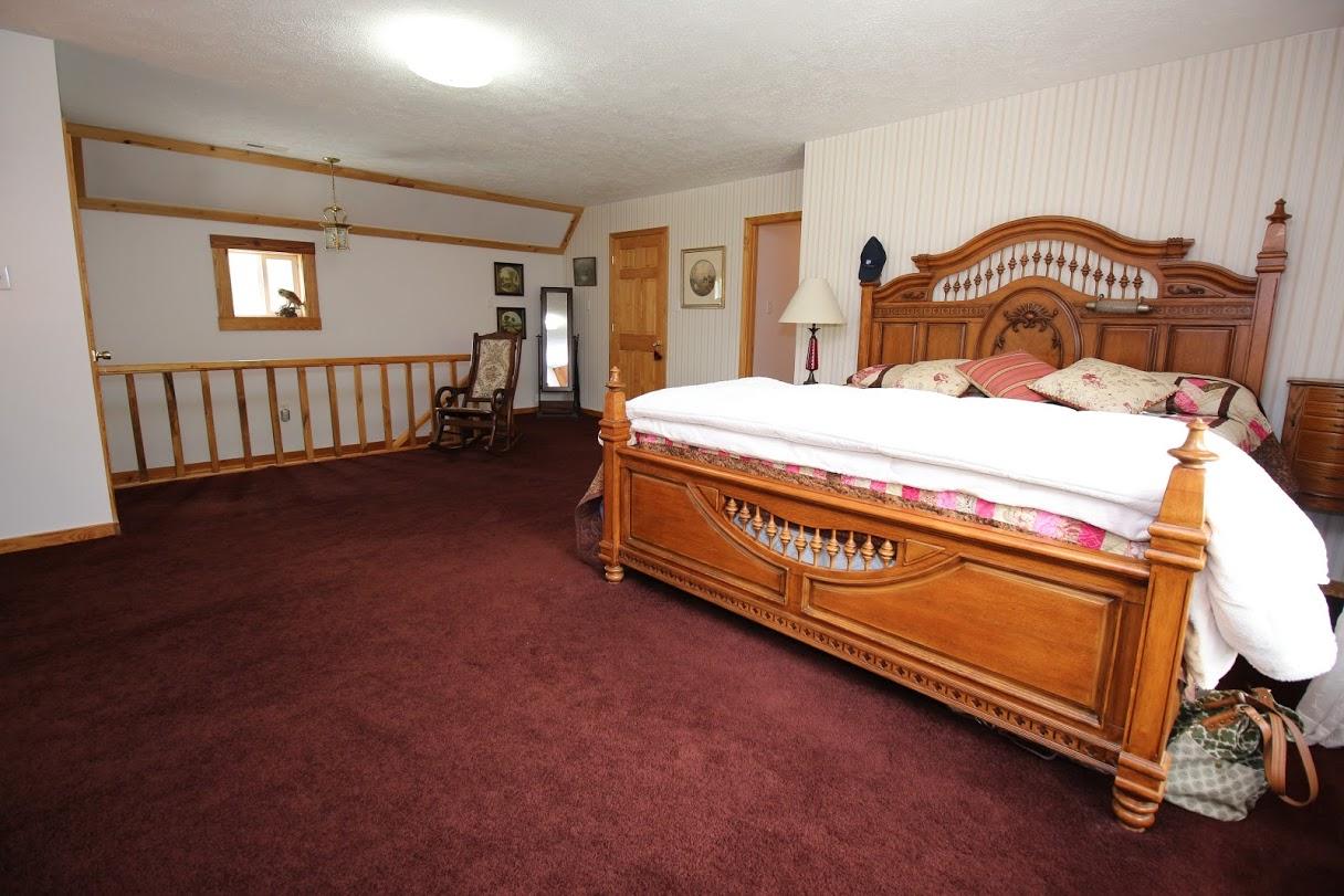 2185 Loops Road Rainelle, WV 25962 - Photo 10 of 109 a spacious bedroom with a bed and dresser
