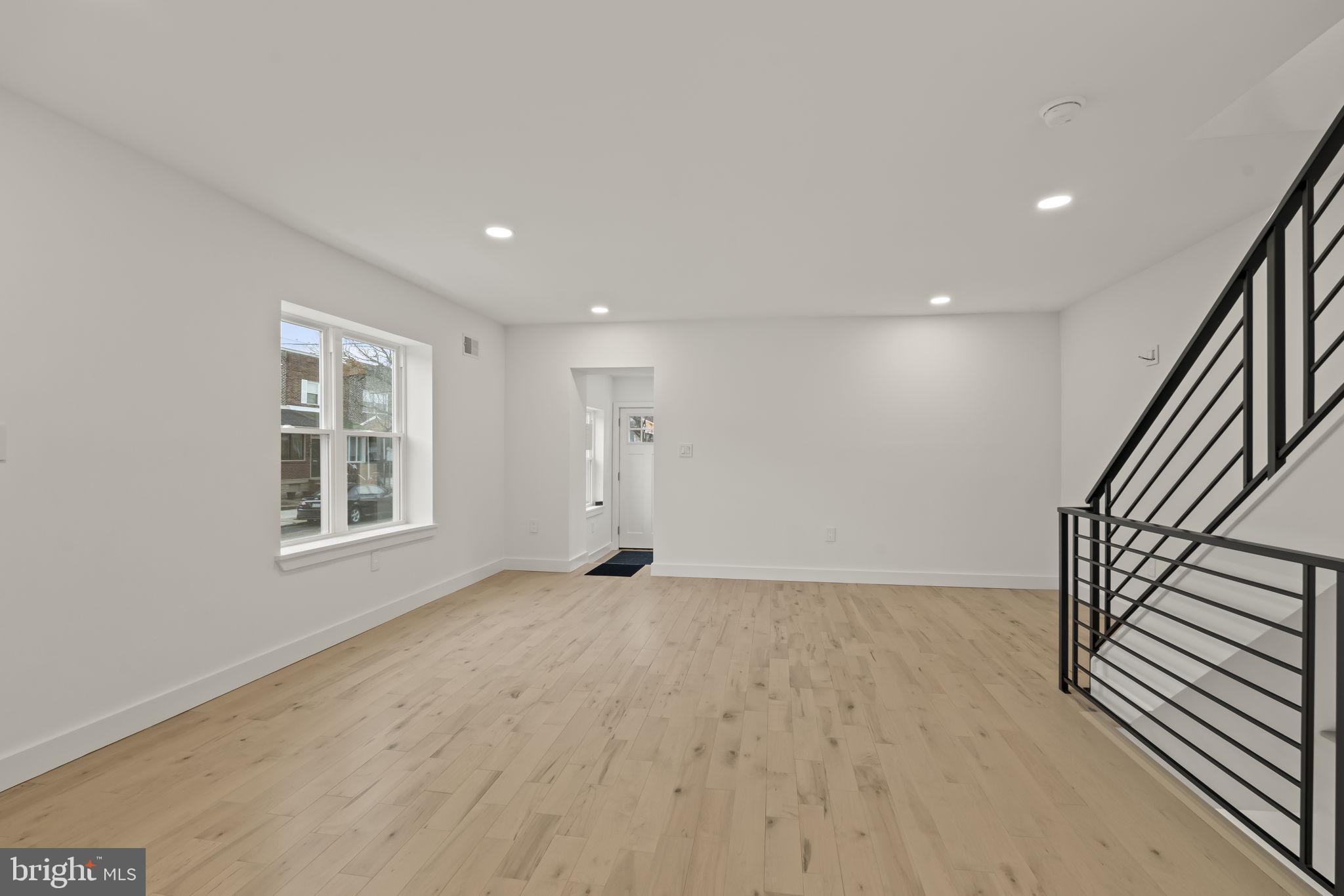 2747 South Beulah Street Philadelphia, PA 19148 - Photo 14 of 37 a view of an empty room with wooden floor and a window