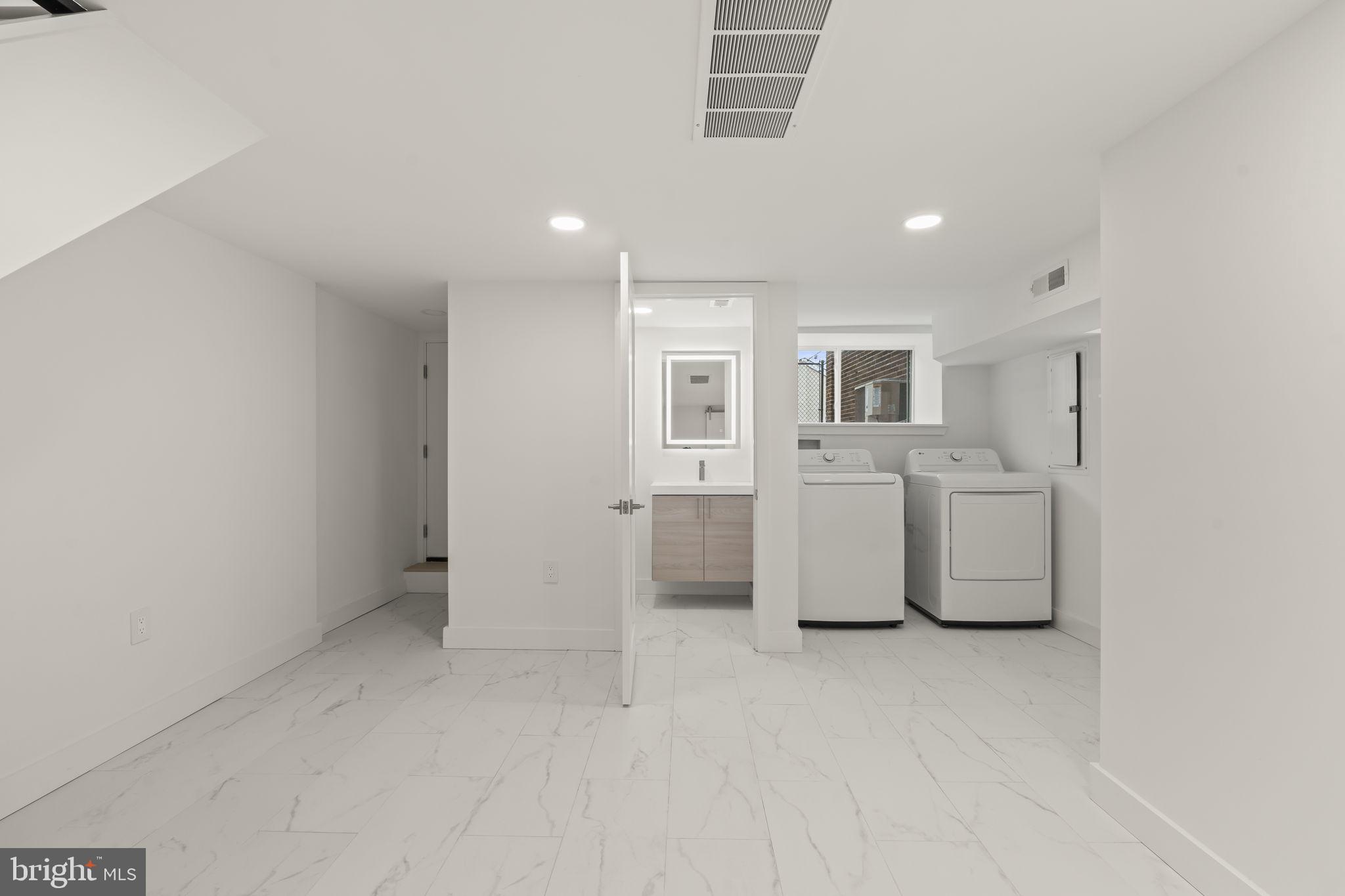 2747 South Beulah Street Philadelphia, PA 19148 - Photo 28 of 37 a view of a kitchen with white cabinets and wooden floor