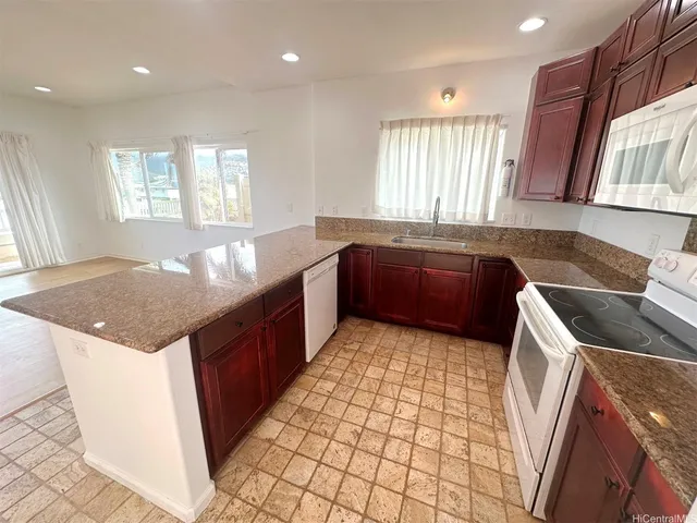 a kitchen with a sink a counter top space and cabinets