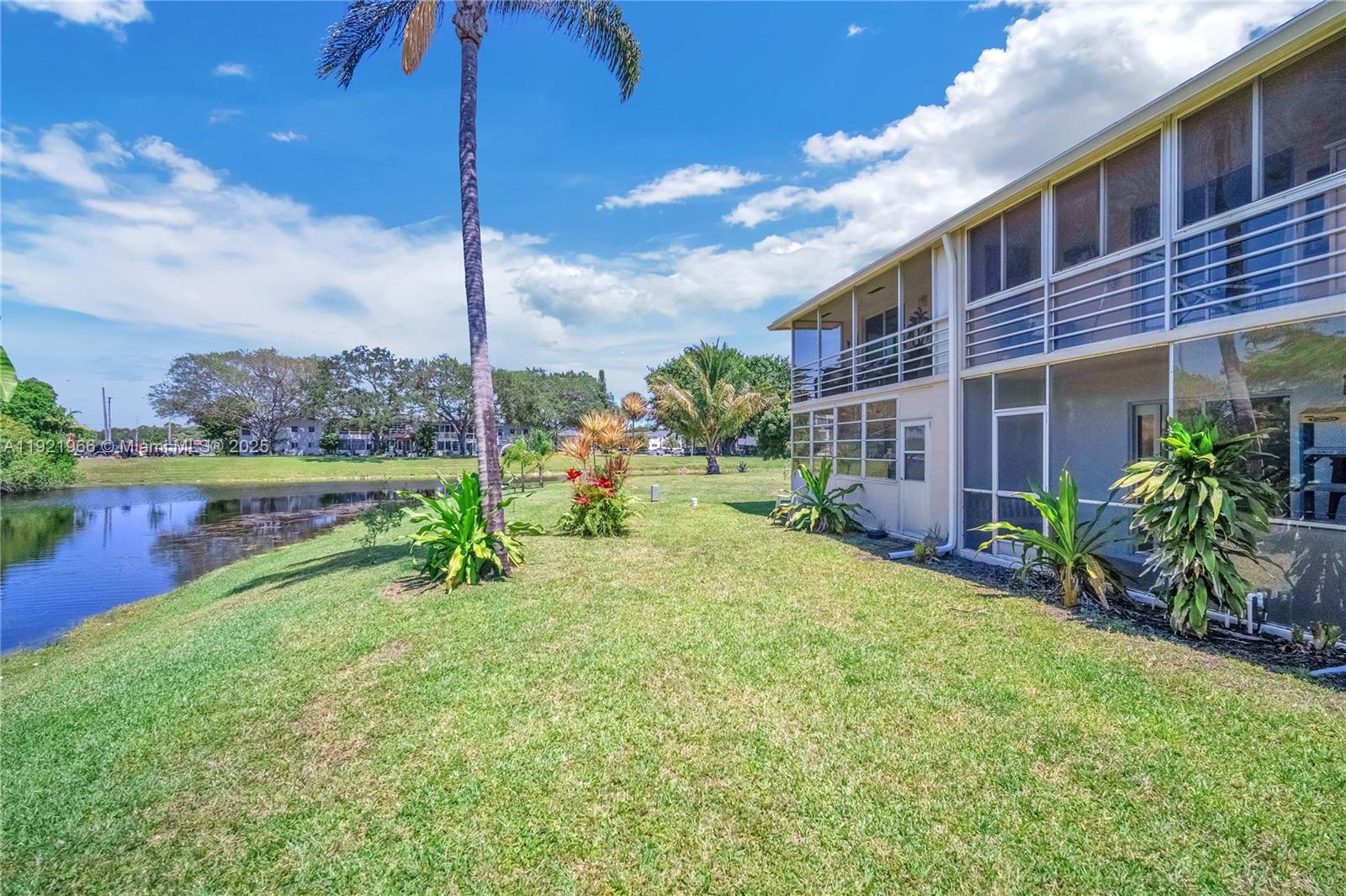 244 Durham, Unit 244 Deerfield Beach, FL 33442 - Photo 11 of 20 a front view of a house with a yard table and chairs