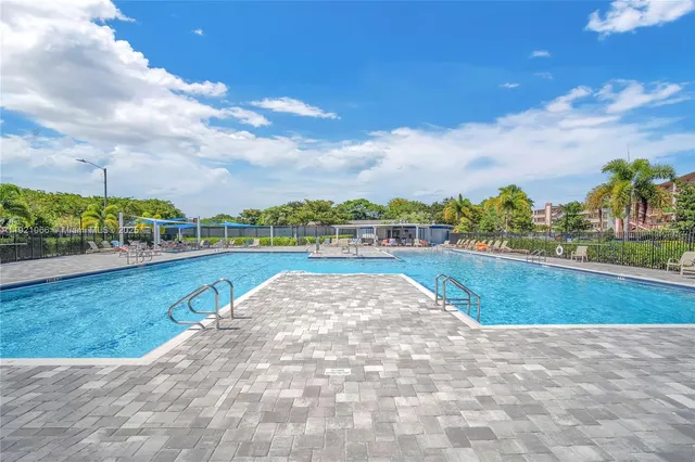 a view of a swimming pool with a table and chairs