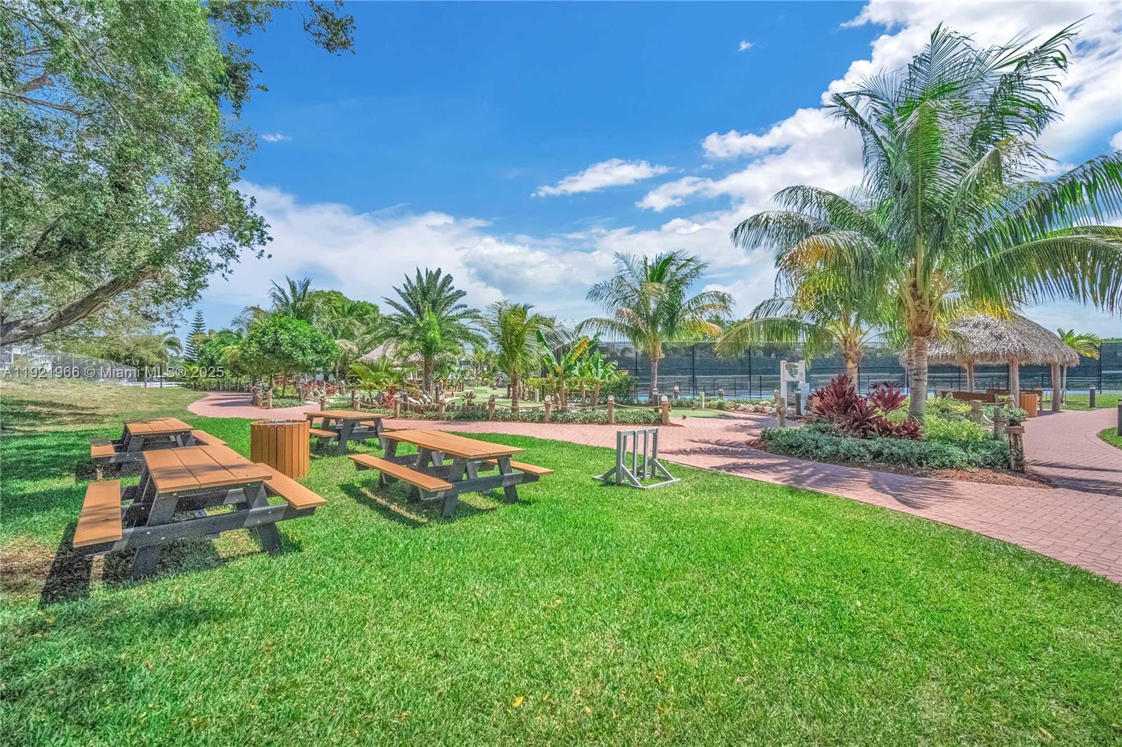 244 Durham, Unit 244 Deerfield Beach, FL 33442 - Photo 19 of 20 a view of a swimming pool with a table and chairs