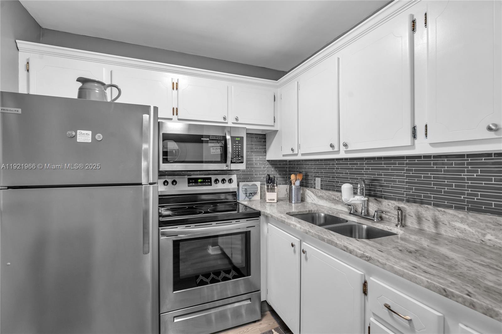 244 Durham, Unit 244 Deerfield Beach, FL 33442 - Photo 2 of 20 a kitchen with stainless steel appliances a refrigerator sink and microwave