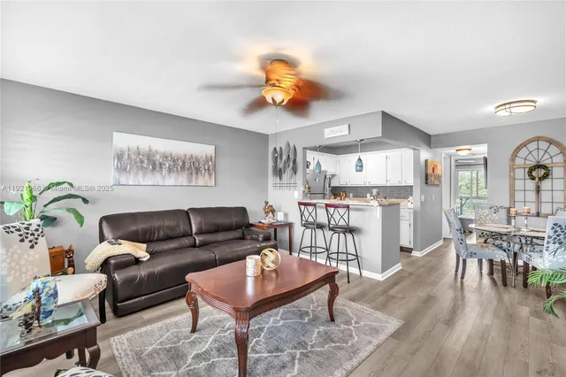a living room with furniture and kitchen view