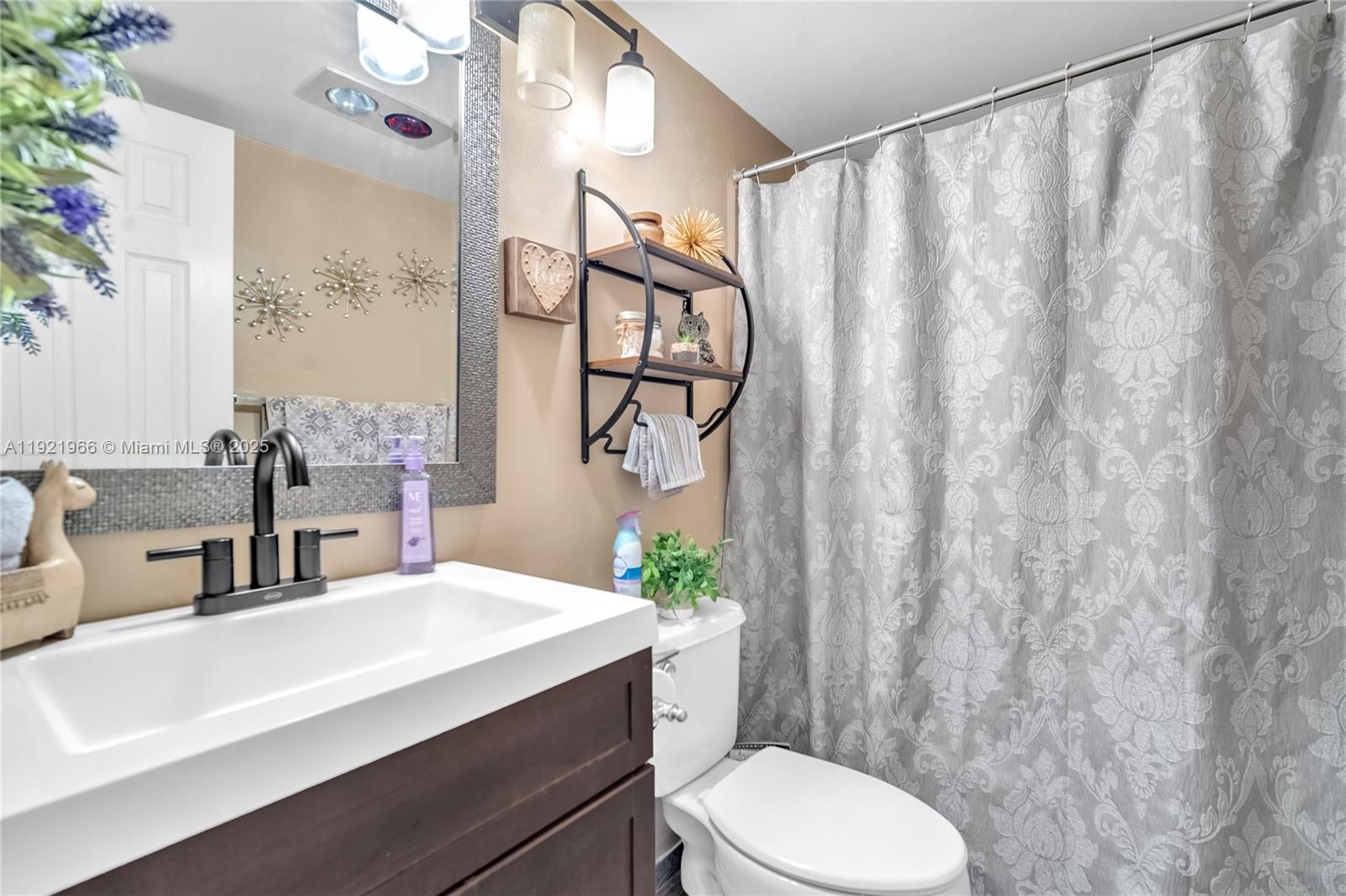 244 Durham, Unit 244 Deerfield Beach, FL 33442 - Photo 7 of 20 a bathroom with a sink a toilet and shower curtain