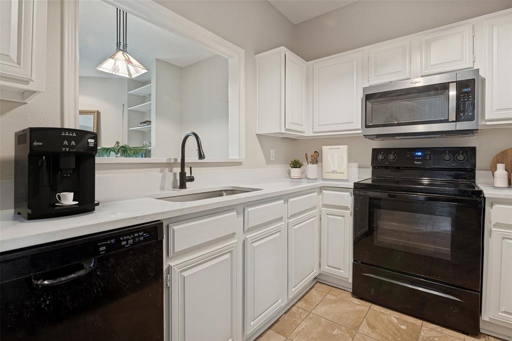 14277 Preston Road, Unit 1012 Dallas, TX 75254 - Photo 4 of 13 Kitchen was recently updated with quartz countertops, fresh paint and a new stainless steel microwave