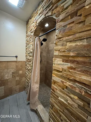 a bathroom with a toilet and a shower