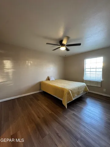 a bedroom with a large bed and a window