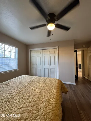 a view of a livingroom with a ceiling fan and window