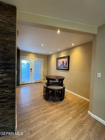 a view of kitchen with refrigerator and wooden floor