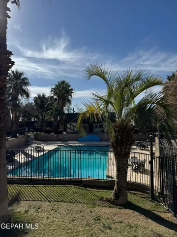 a view of swimming pool with outdoor seating and yard