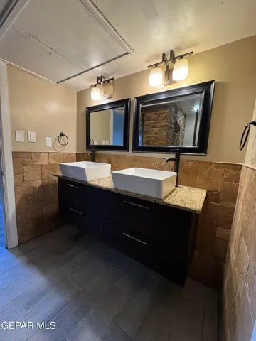 a bathroom with a sink double vanity and a mirror