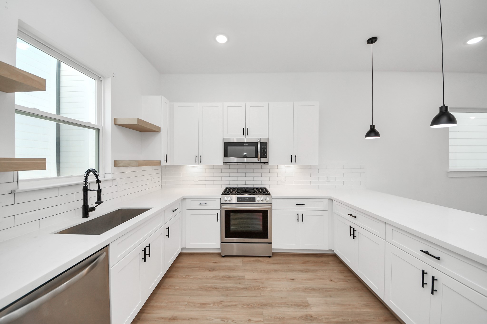 4806 Cochran Street Houston, TX 77009 - Photo 16 of 43 a kitchen with white cabinets and appliances