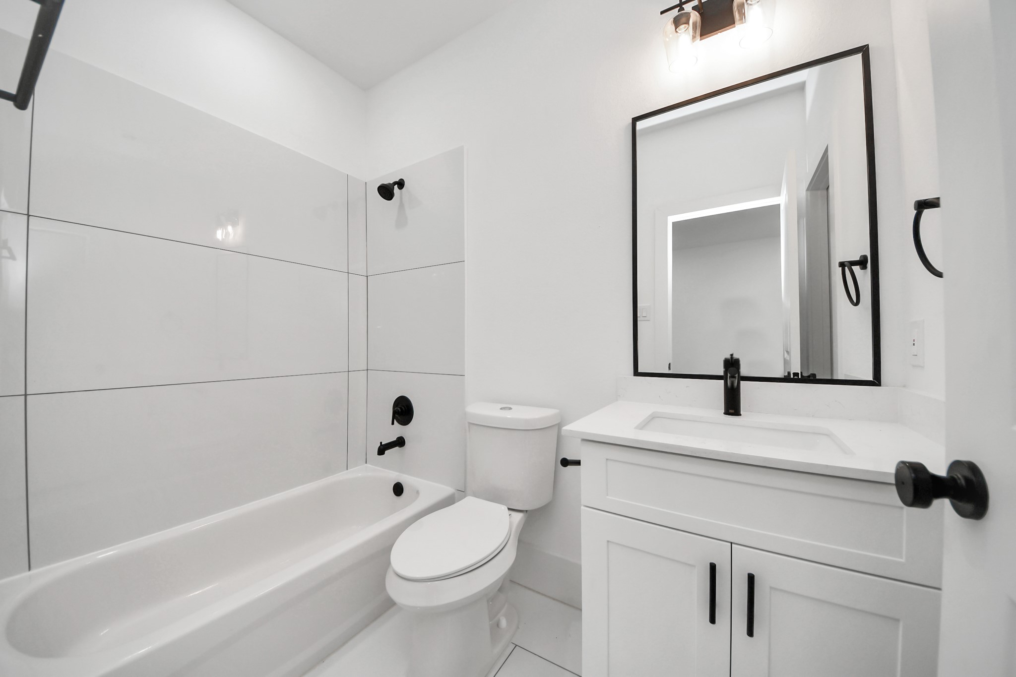 4806 Cochran Street Houston, TX 77009 - Photo 21 of 43 a bathroom with a sink a toilet and a mirror