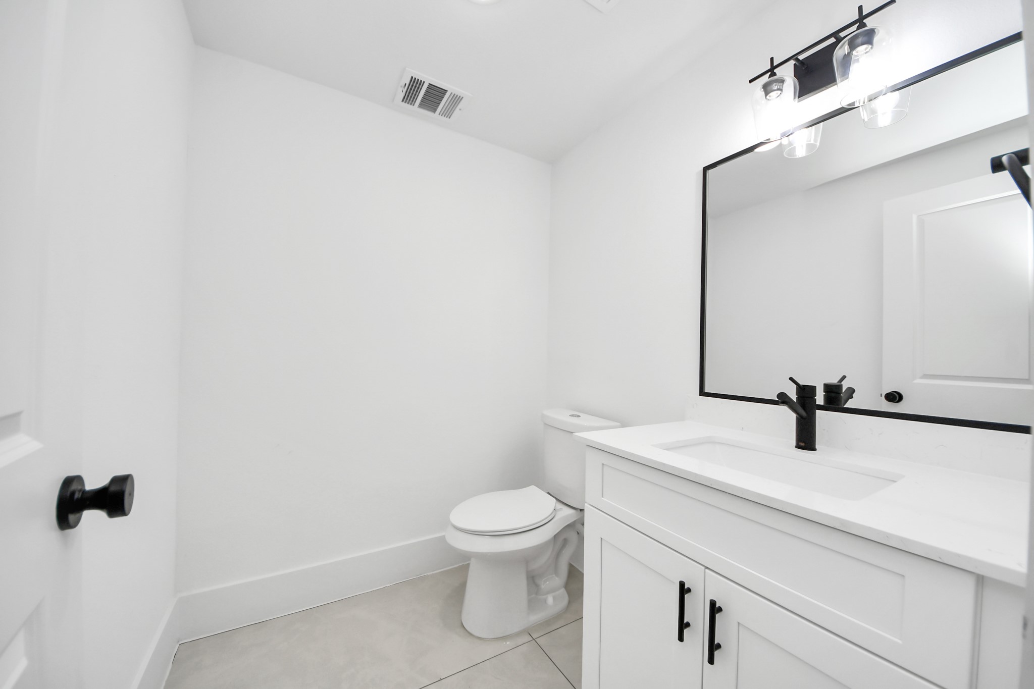 4806 Cochran Street Houston, TX 77009 - Photo 23 of 43 a bathroom with a sink a toilet and mirror