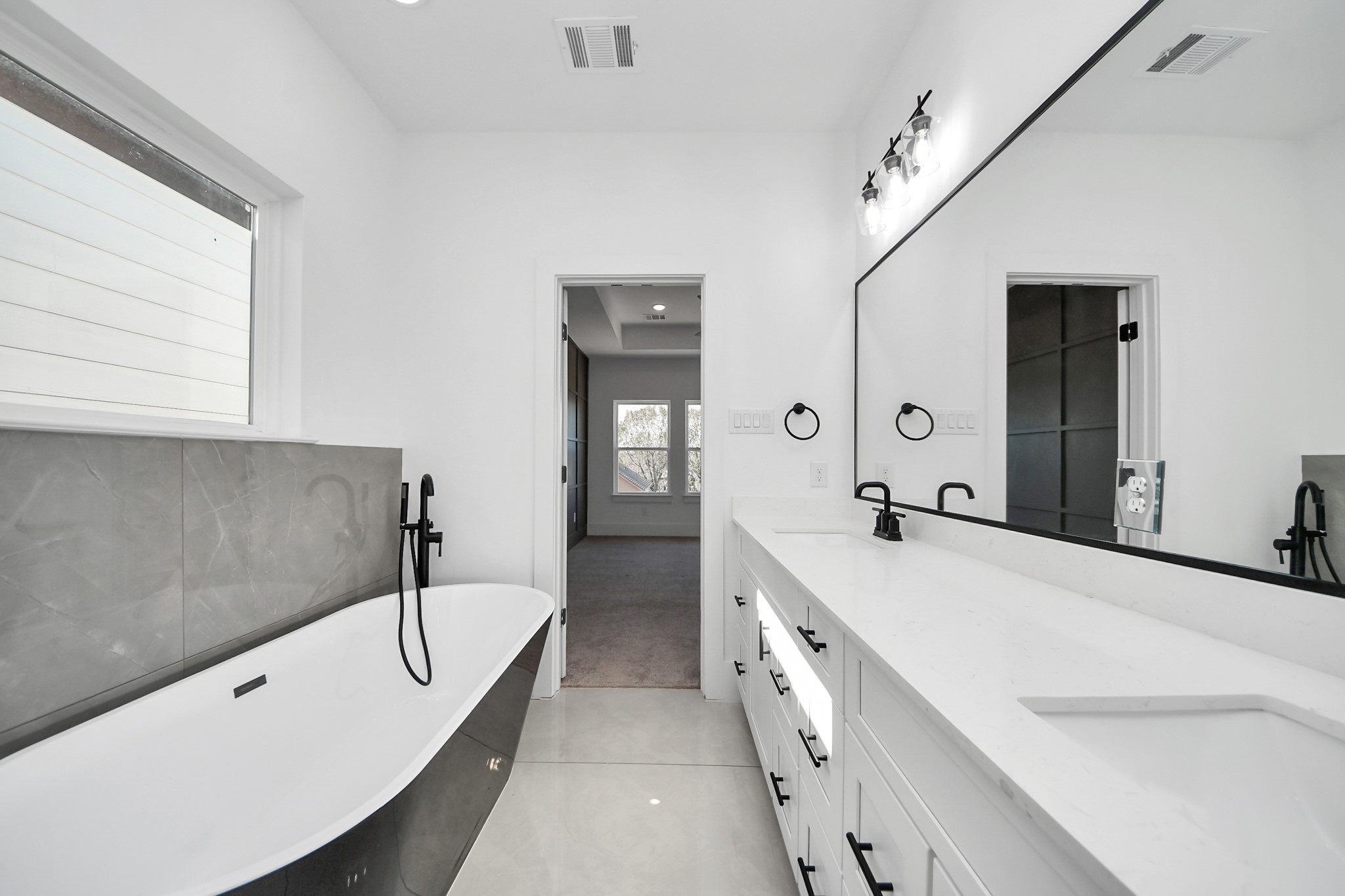 4806 Cochran Street Houston, TX 77009 - Photo 32 of 43 a spacious bathroom with a tub sink and mirror