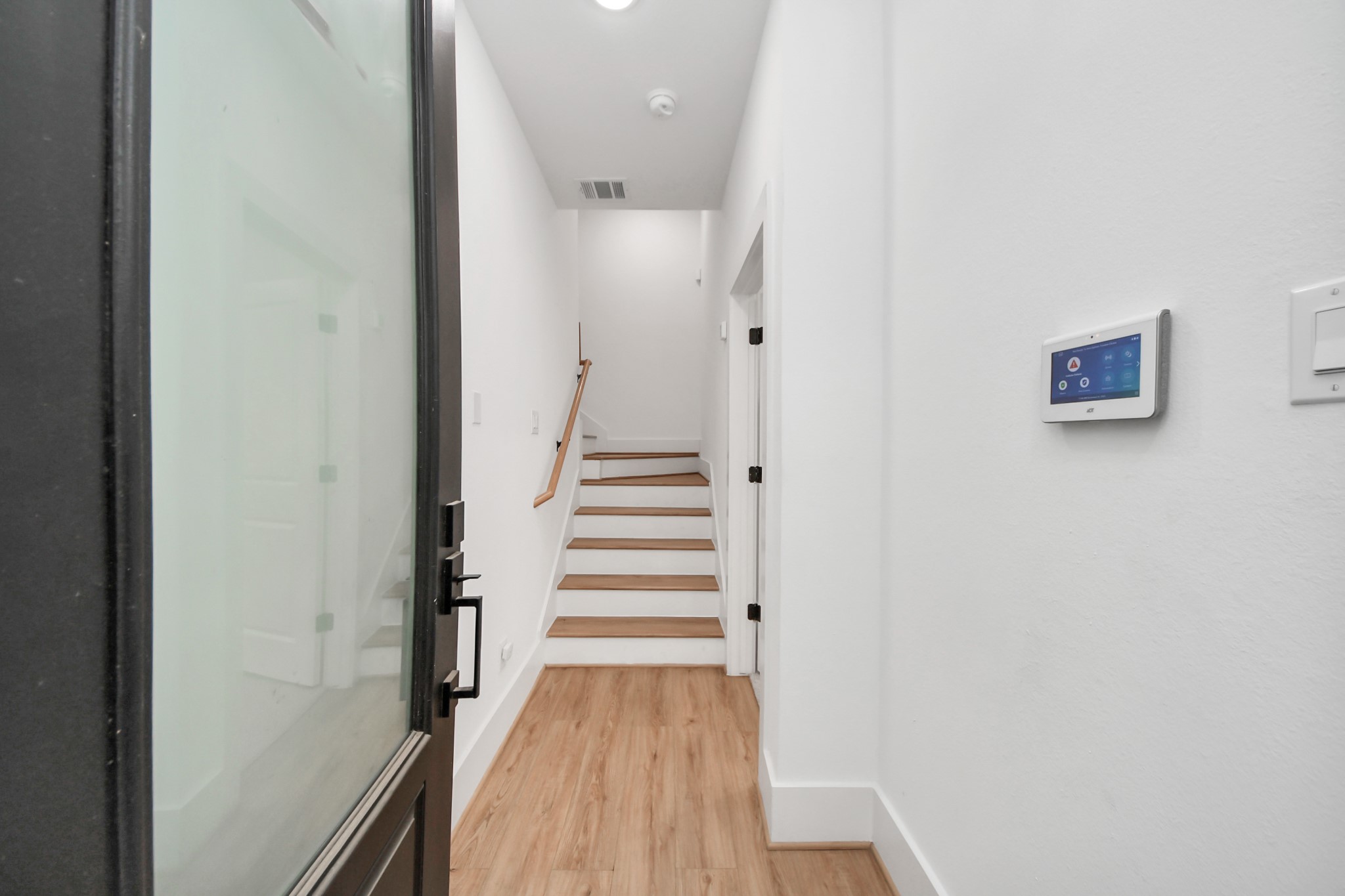 4806 Cochran Street Houston, TX 77009 - Photo 4 of 43 a view of a hallway with wooden floor and entryway