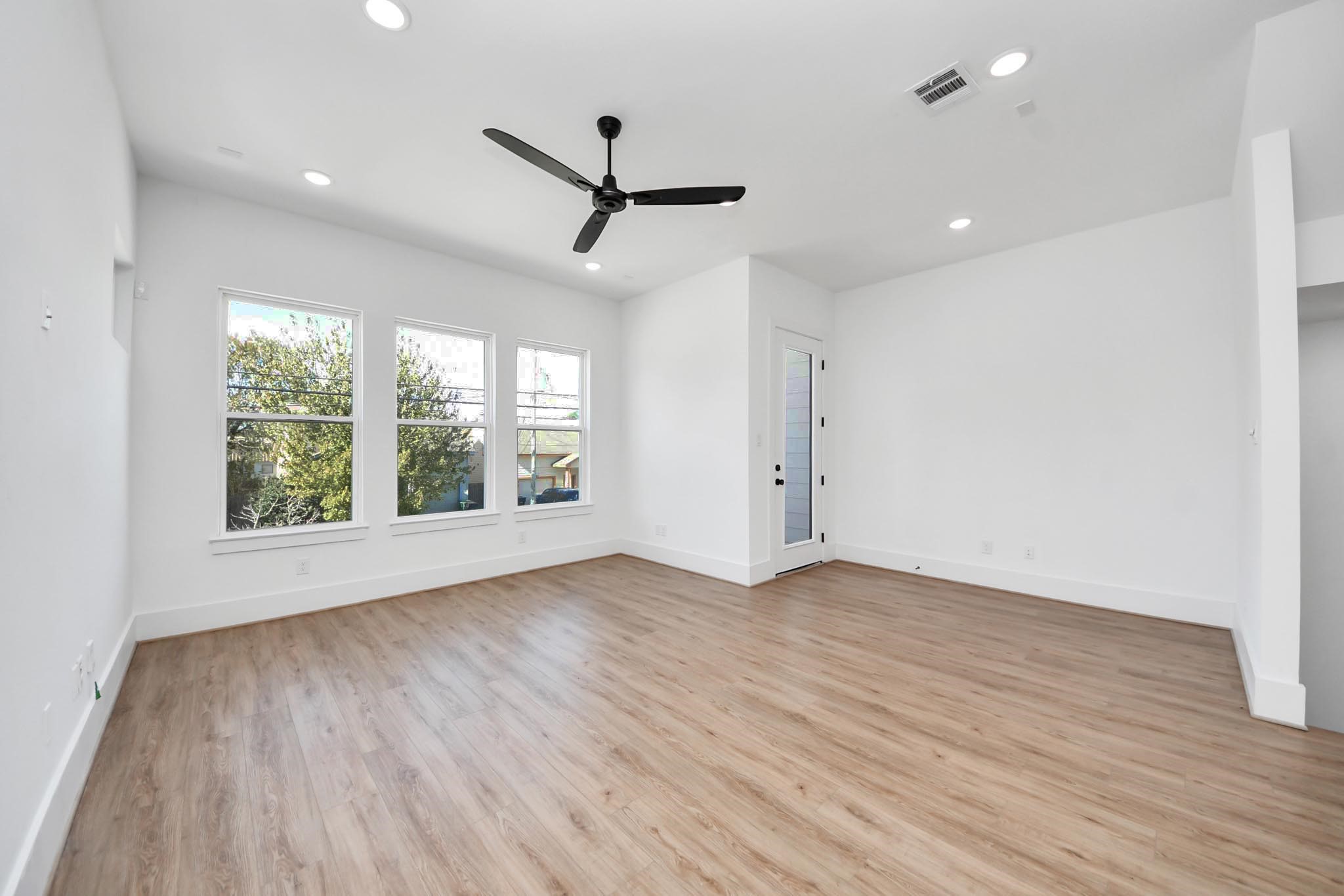4806 Cochran Street Houston, TX 77009 - Photo 6 of 43 a view of empty room with wooden floor and fan