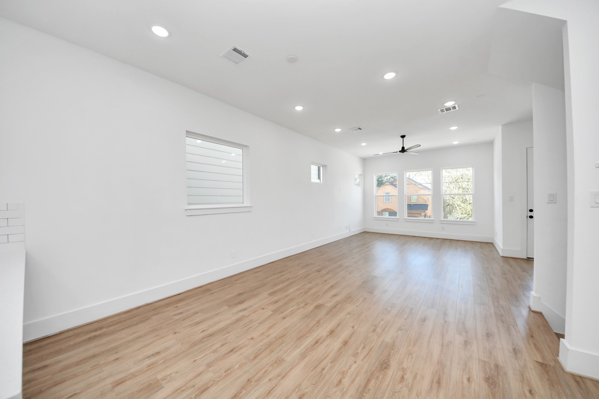 4806 Cochran Street Houston, TX 77009 - Photo 9 of 43 an empty room with wooden floor and windows