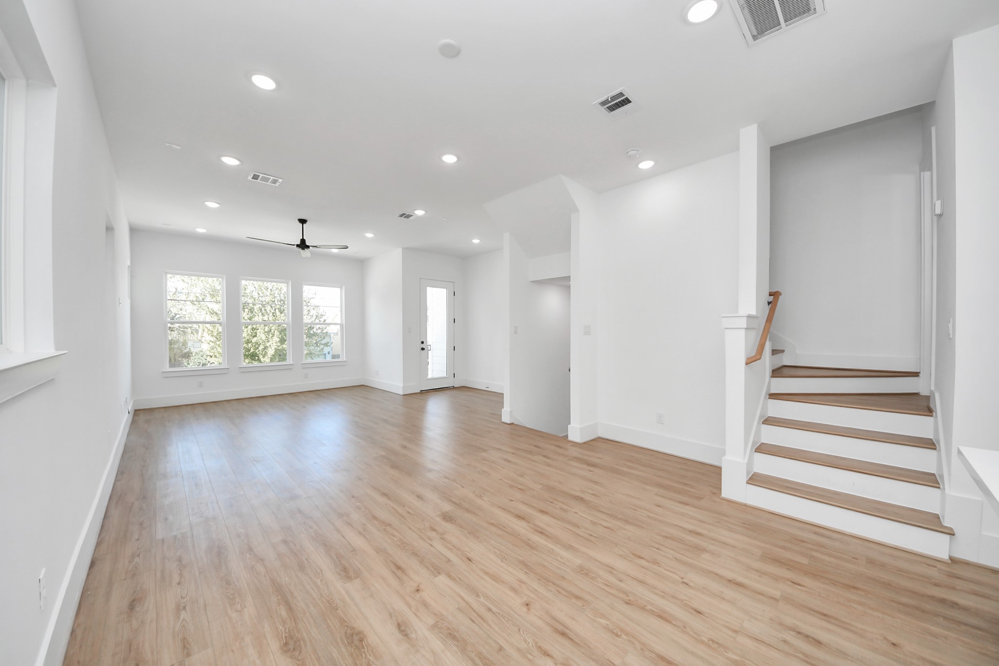 4806 Cochran Street Houston, TX 77009 - Photo 10 of 43 an empty room with wooden floor and windows
