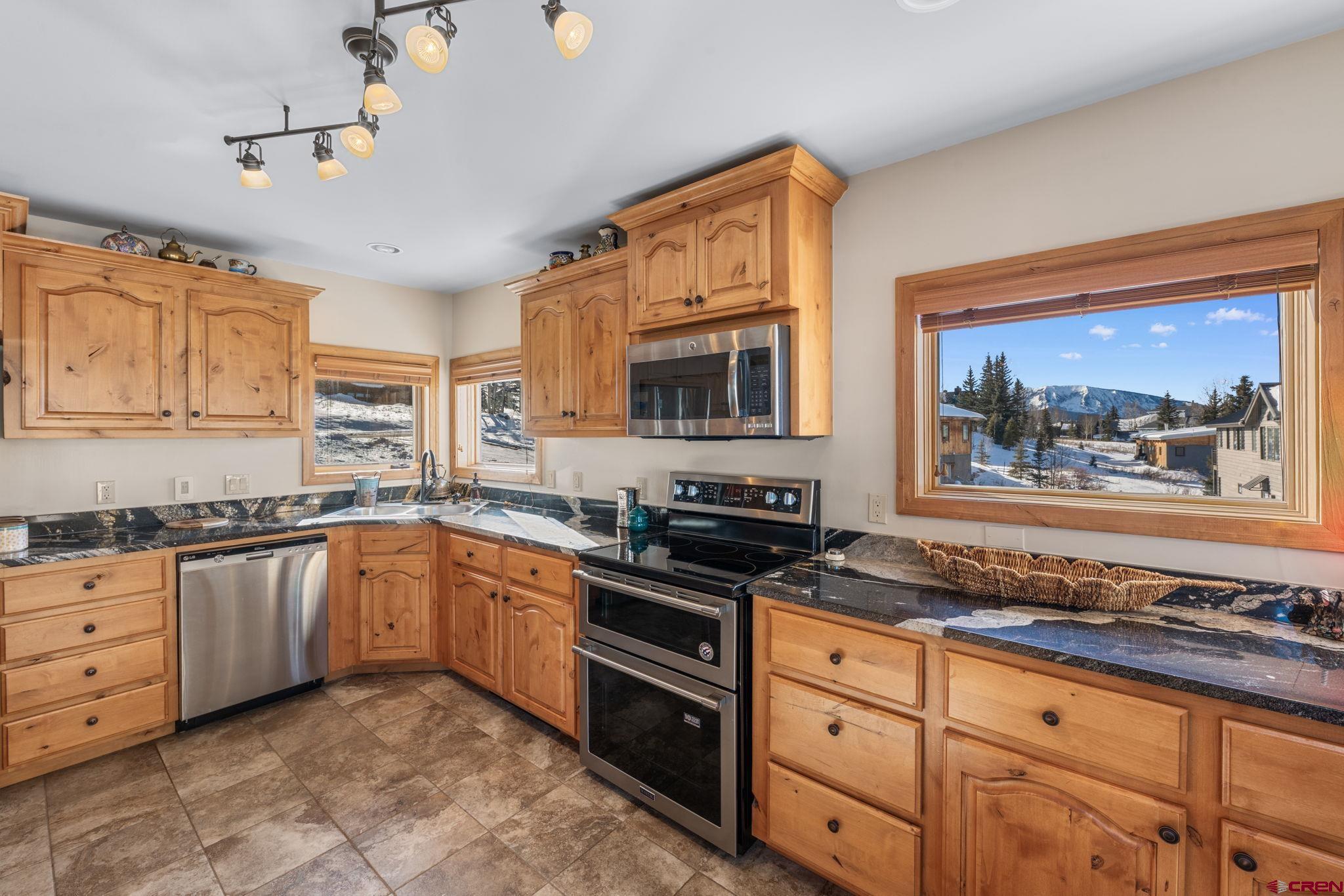 10 Ruby Drive Crested Butte, CO 81225 - Photo 13 of 42 a kitchen with stainless steel appliances granite countertop a stove sink and cabinets