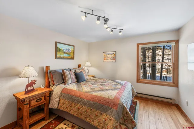 a bathroom with a granite countertop shower sink vanity and mirror