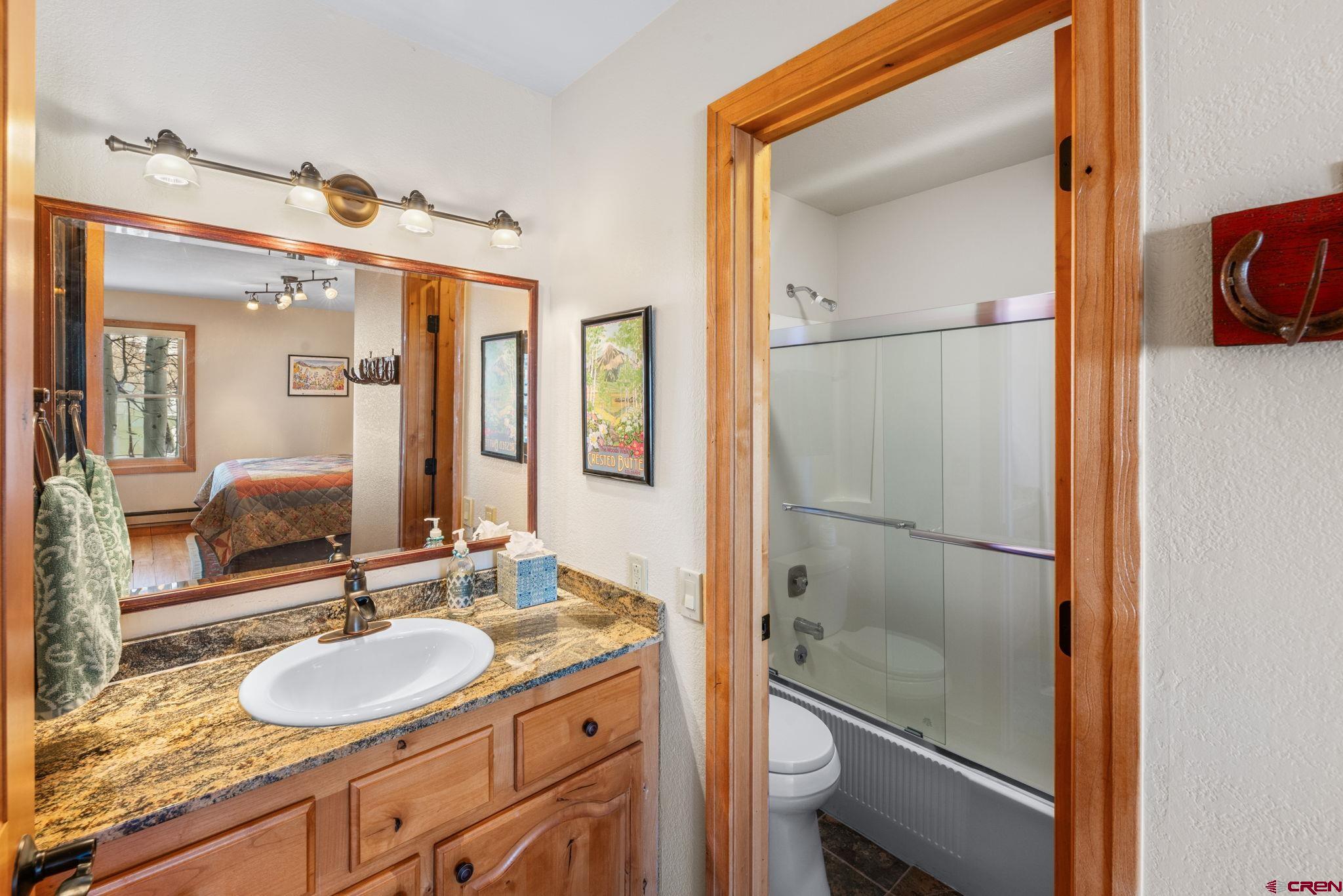 10 Ruby Drive Crested Butte, CO 81225 - Photo 36 of 42 a bathroom with a granite countertop sink mirror and a shower