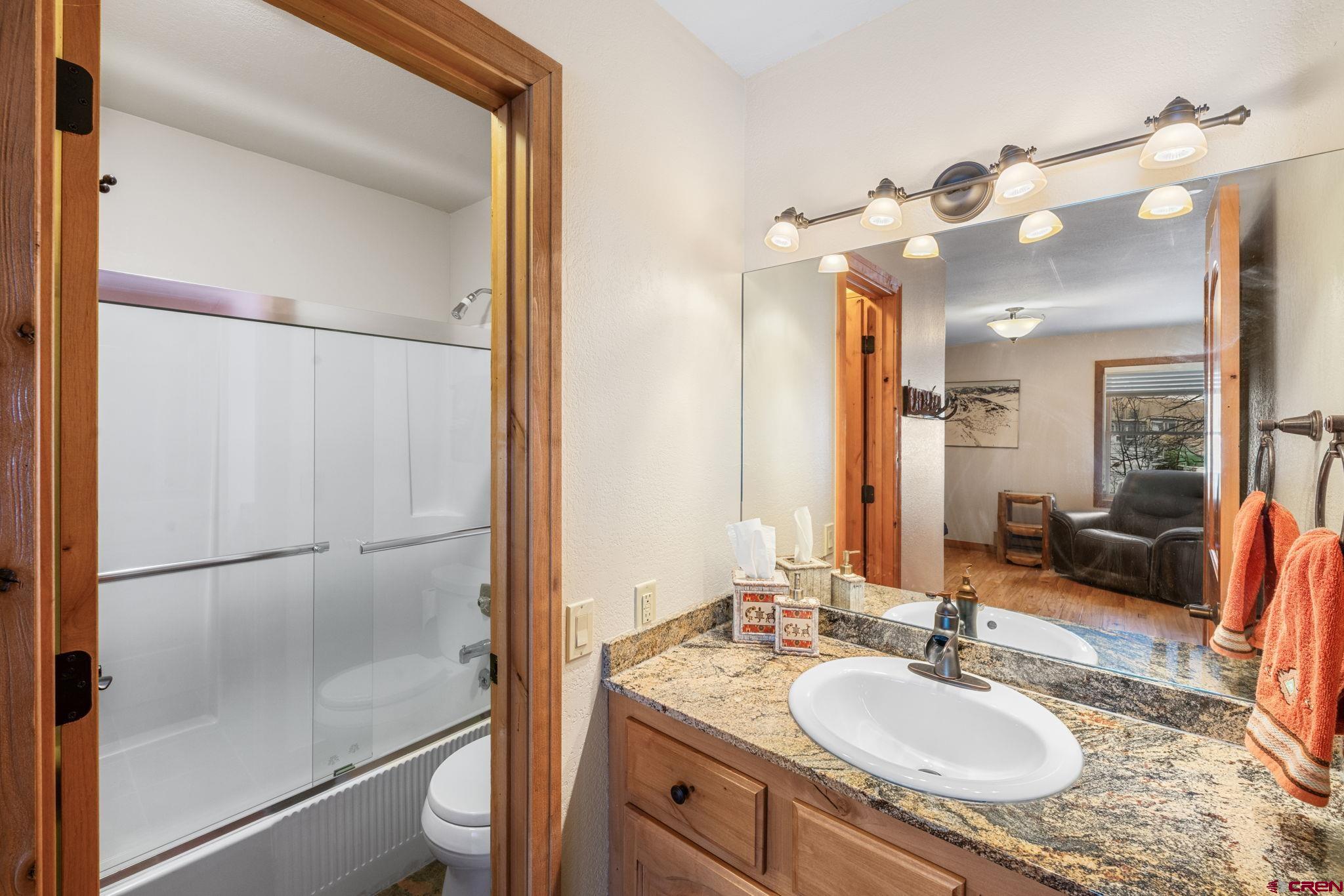 10 Ruby Drive Crested Butte, CO 81225 - Photo 38 of 42 a bathroom with a granite countertop shower sink vanity and mirror