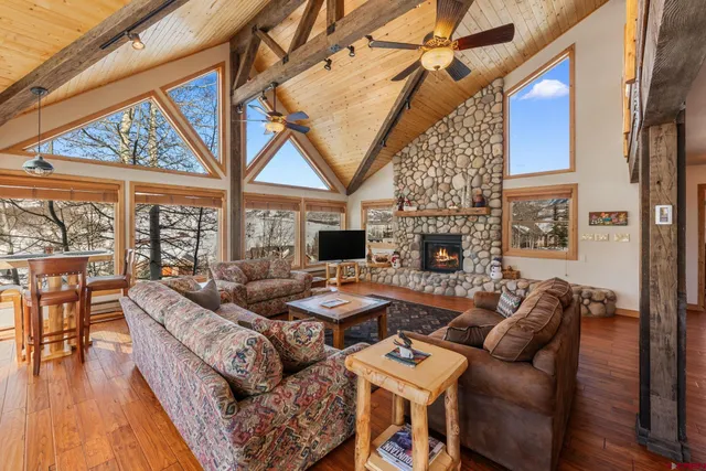 a kitchen with stainless steel appliances granite countertop a table chairs sink refrigerator and microwave