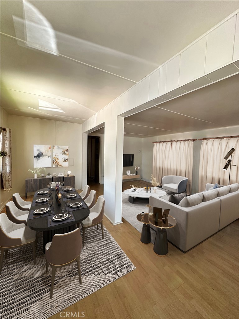 8600 Contreras Street Paramount, CA 90723 - Photo 1 of 1 a living room with furniture and a wooden floor