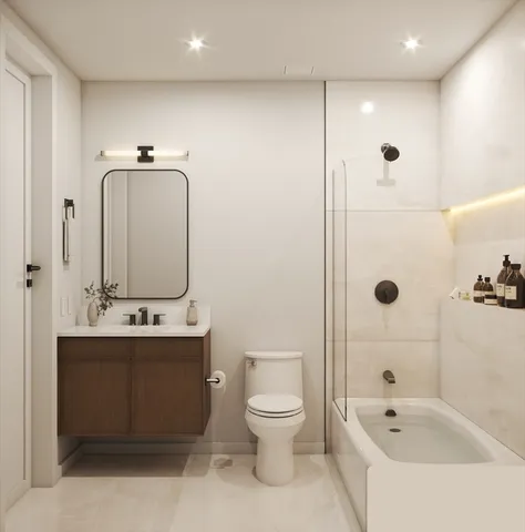 a bathroom with a toilet a sink and mirror
