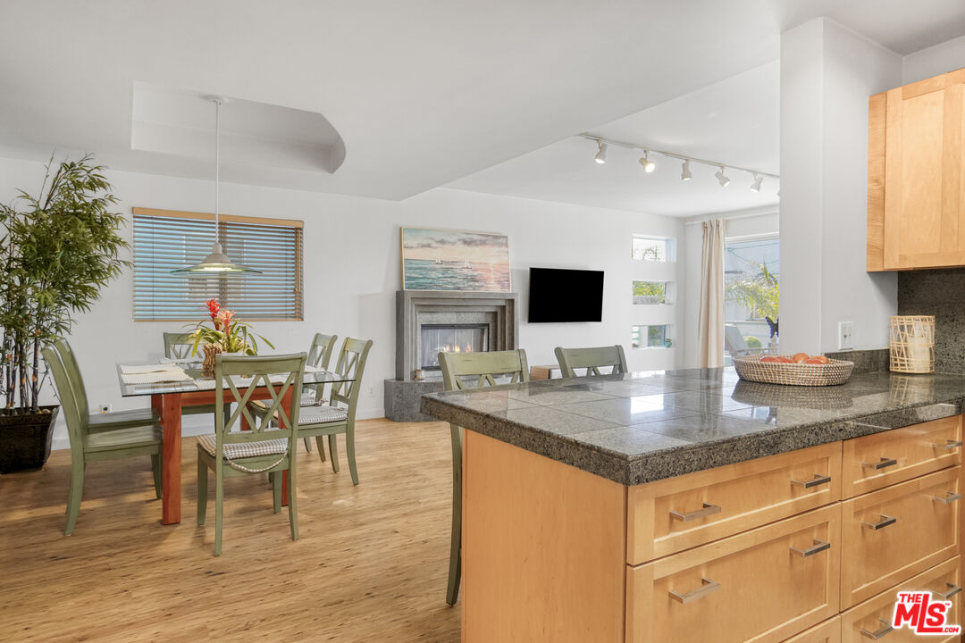 120 Fleet Street, Unit B Marina del Rey, CA 90292 - Photo 15 of 32 a view of kitchen island dining table wooden floor and living room