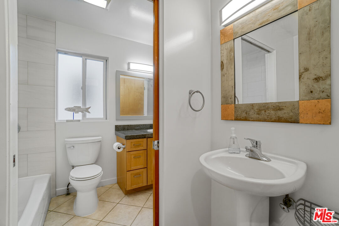 120 Fleet Street, Unit B Marina del Rey, CA 90292 - Photo 16 of 32 a bathroom with a toilet sink and mirror