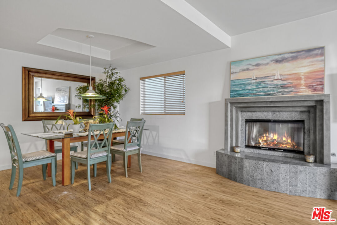120 Fleet Street, Unit B Marina del Rey, CA 90292 - Photo 3 of 32 a dining room with furniture a fireplace and wooden floor