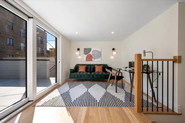 a living room with furniture and a dining table