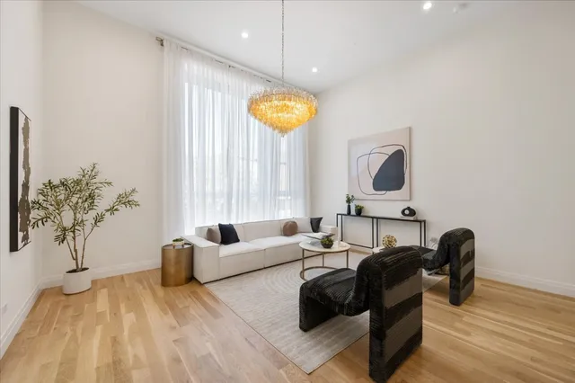 a dining room with wooden floor a glass table and chairs