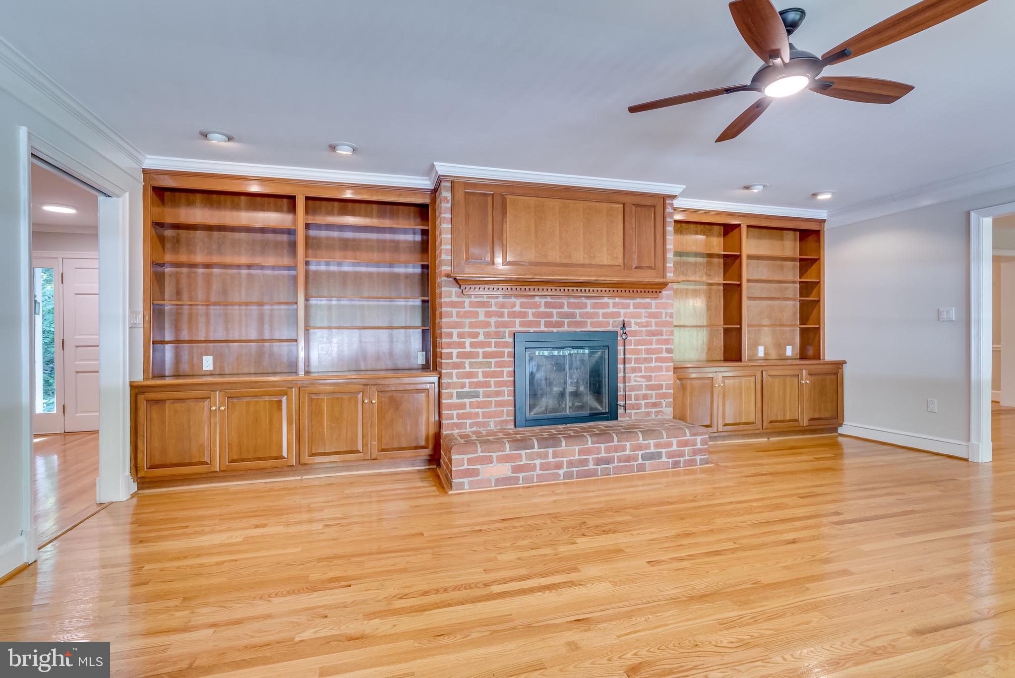 Built ins adorn the fireplace in fam rm