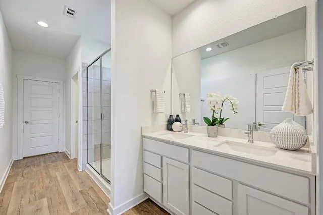a bathroom with a double vanity sink and mirror