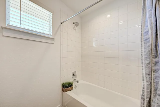 a bathroom with a bathtub and shower