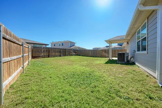 a view of a house with backyard and porch