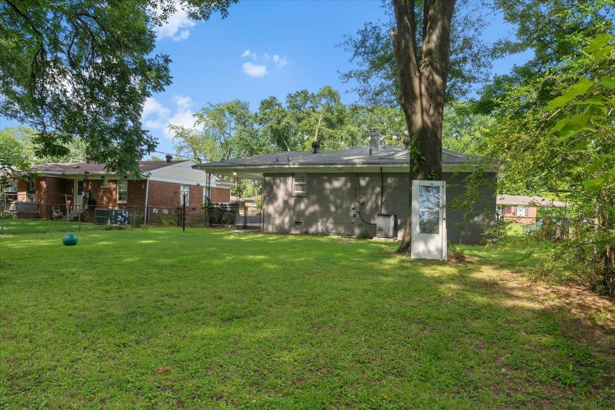 2717 Merle Street Memphis, TN 38118 - Photo 18 of 18 Expansive grassy yard with mature trees and a privacy fence