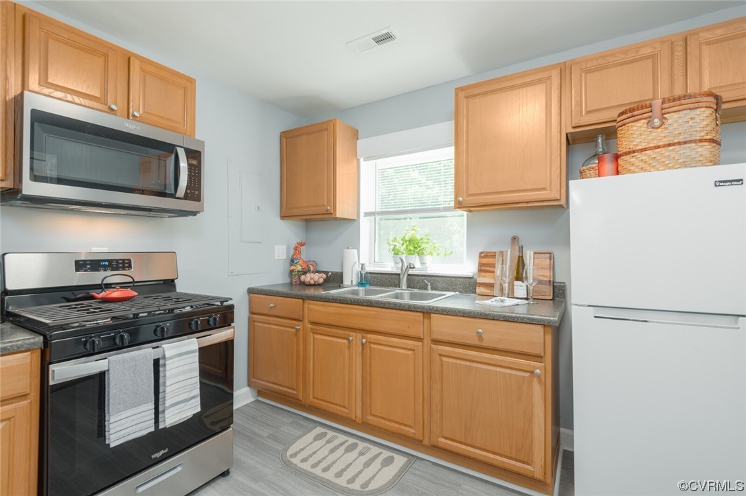 2441 Osborne Road Chester, VA 23831 - Photo 11 of 29 a kitchen with stainless steel appliances granite countertop a stove a sink and a refrigerator
