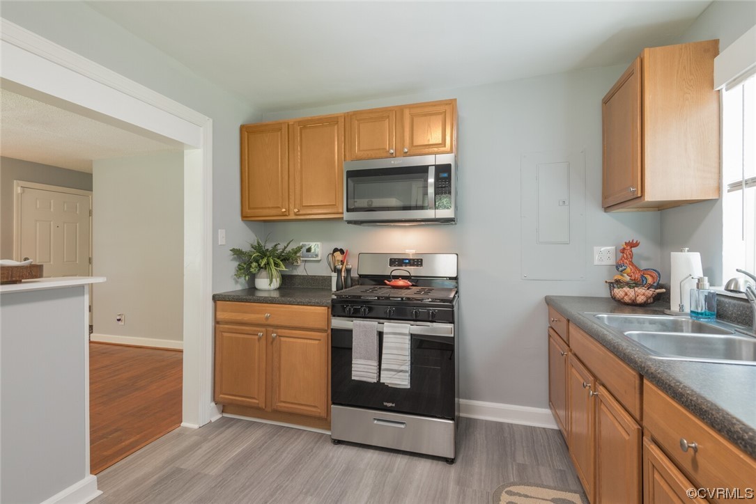 2441 Osborne Road Chester, VA 23831 - Photo 12 of 29 a kitchen with stainless steel appliances granite countertop a stove a sink and a microwave