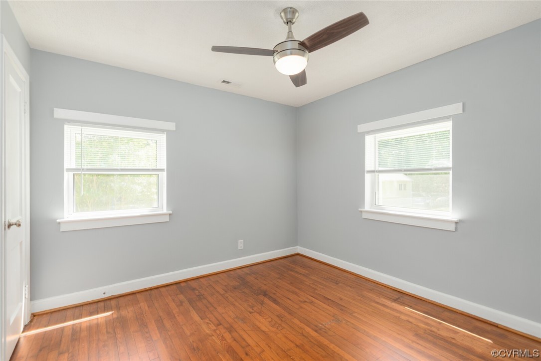 2441 Osborne Road Chester, VA 23831 - Photo 15 of 29 an empty room with a window and wooden floor