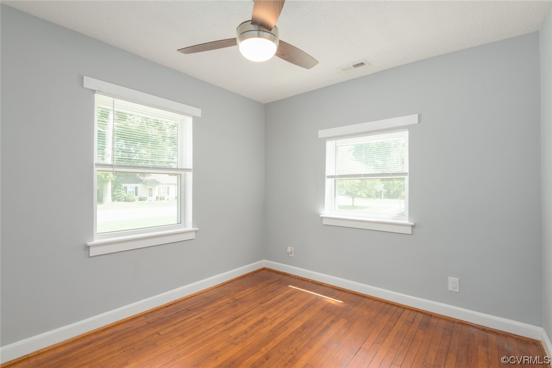 2441 Osborne Road Chester, VA 23831 - Photo 19 of 29 a view of an empty room with wooden floor and a window