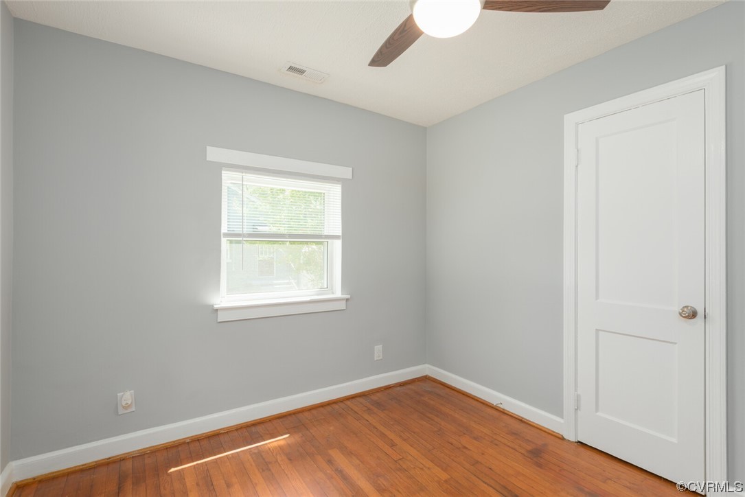 2441 Osborne Road Chester, VA 23831 - Photo 20 of 29 a view of an empty room with wooden floor and a window