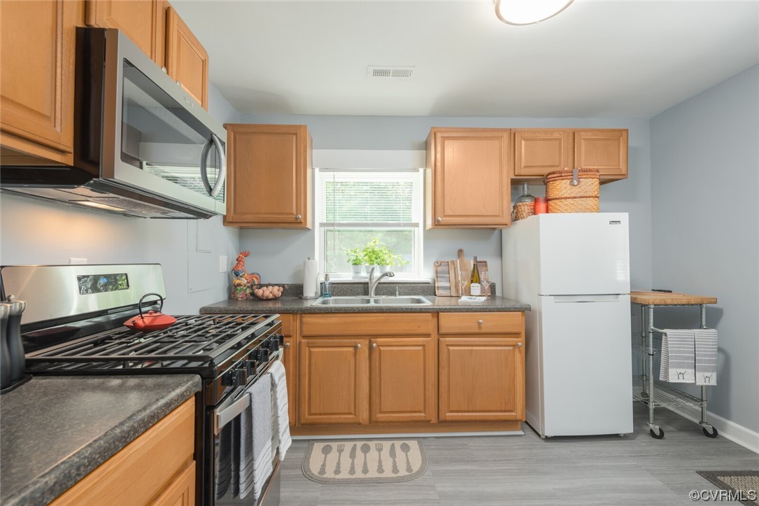 2441 Osborne Road Chester, VA 23831 - Photo 10 of 29 a kitchen with a sink stove and refrigerator